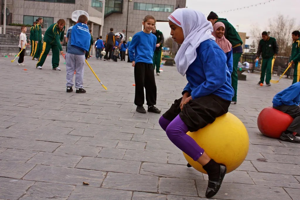 A playground setting with diverse children playing
