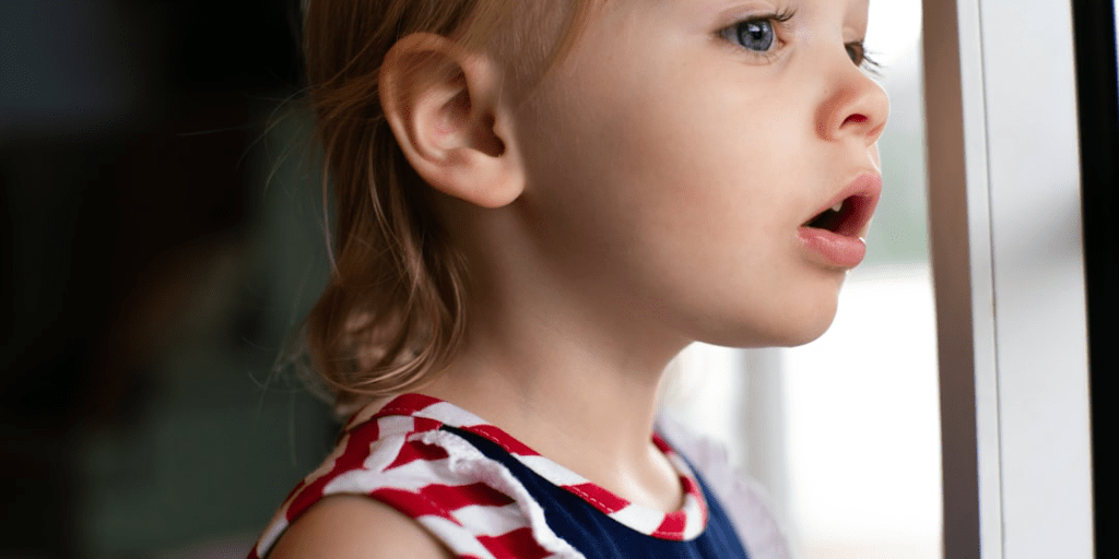A young child looking worried and with their mouth open