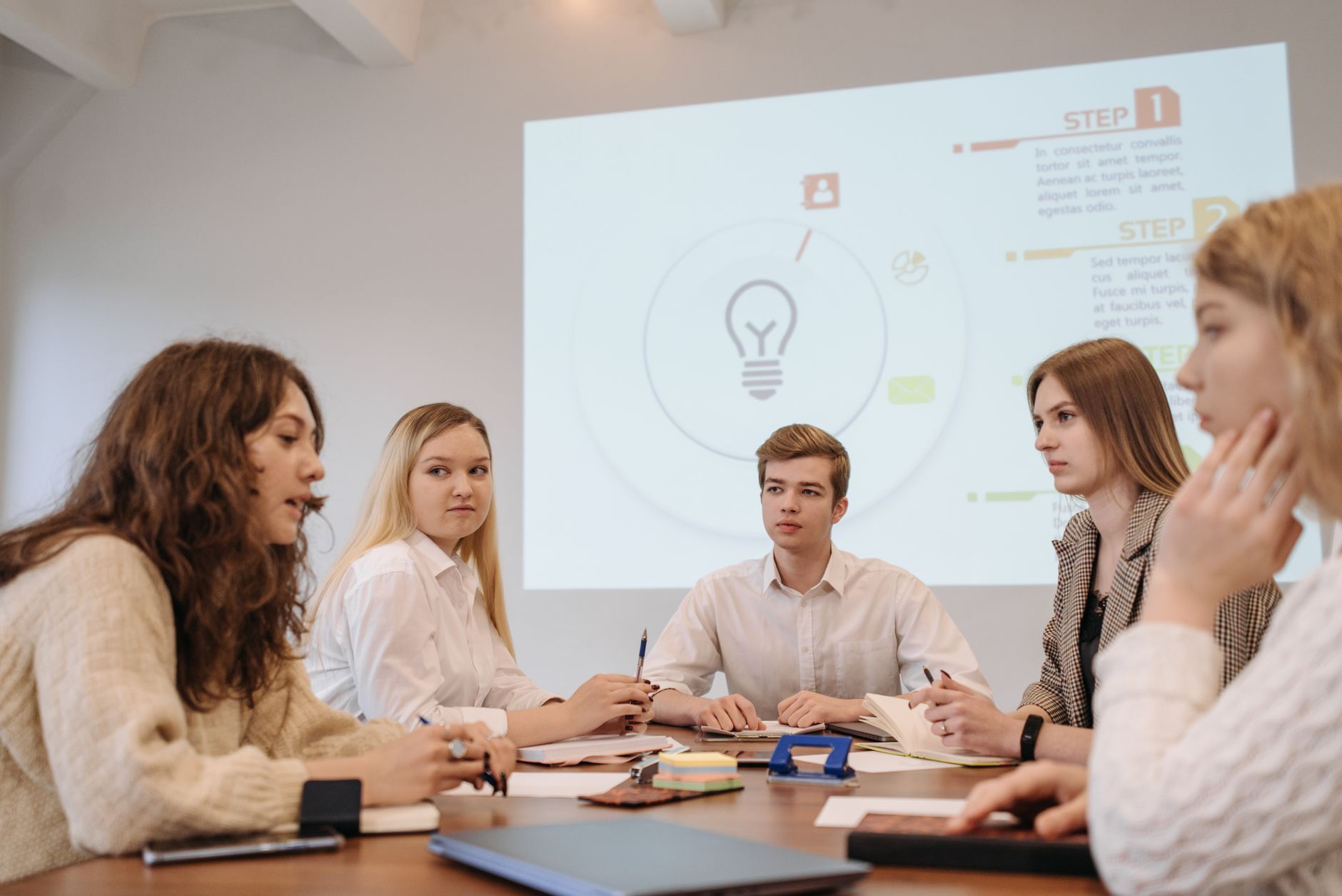 Group of young people sitting at a table and talking